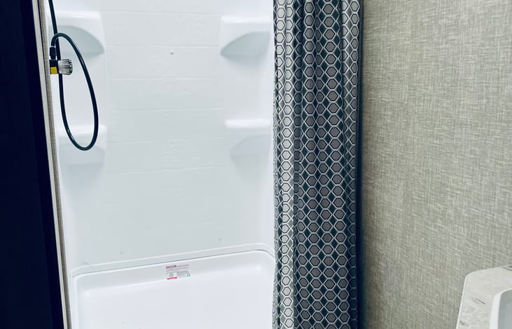 Nice large shower with sink.