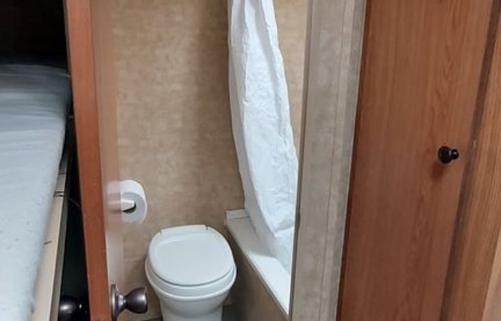 bathroom with toilet, shower and small tub