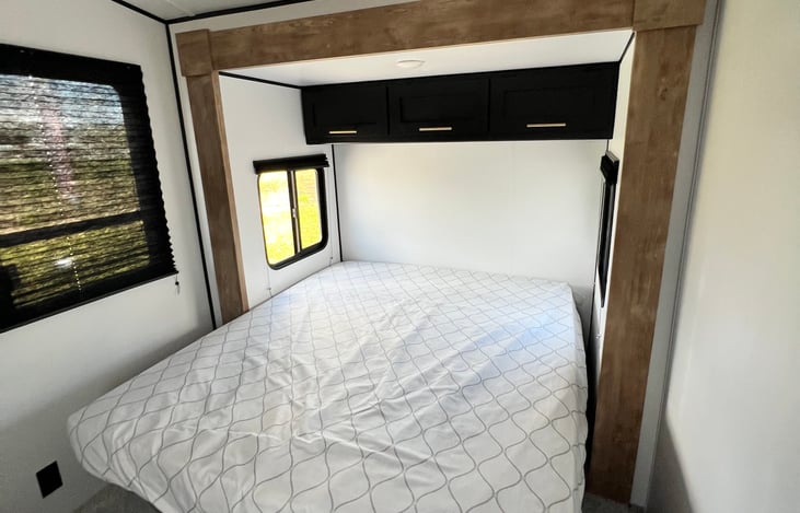 Master bedroom with a camper queen, it's nice and spacey for even the most discerning. Great to get a little privacy on your family trip.