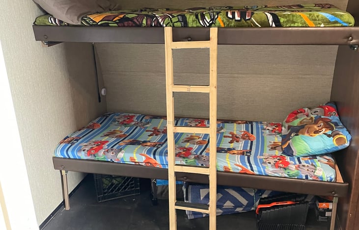 Flip up bunks in the garage, 150# weight limit.