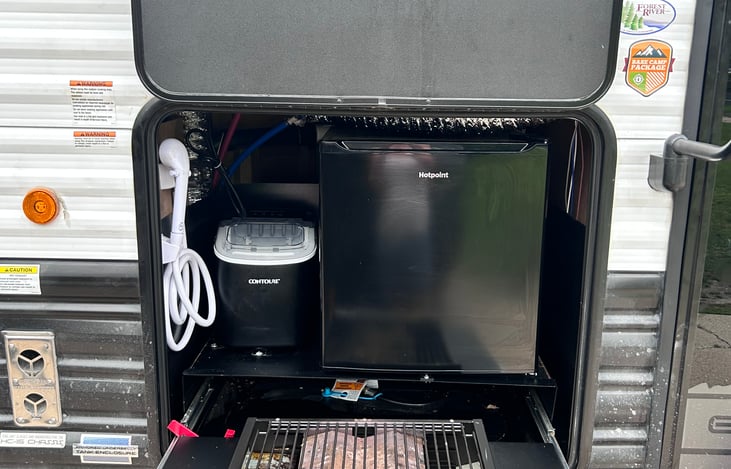 Outdoor shower, ice maker, fridge and grill. There is a flattop attachment that can be placed on top.