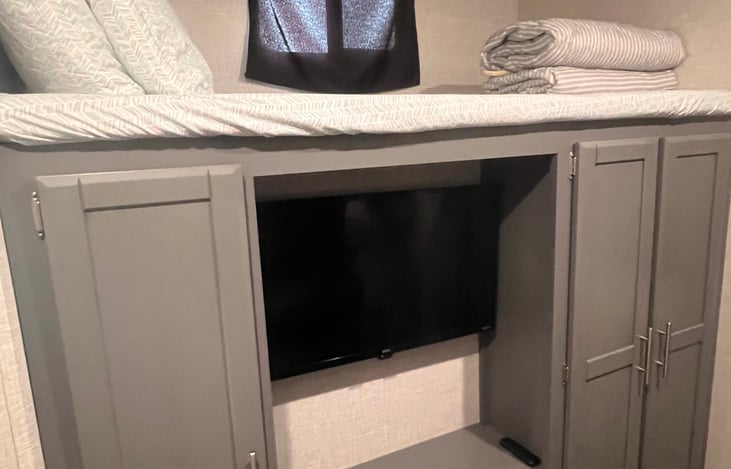 Full bunk with storage and bunk room tv