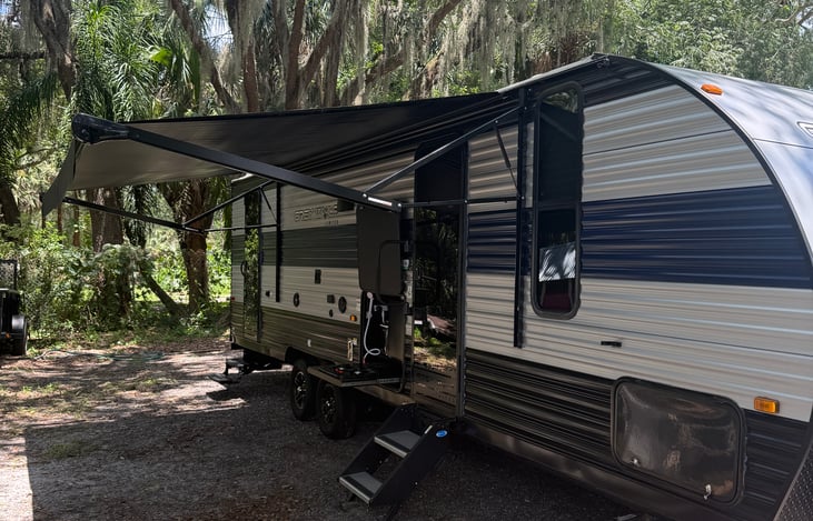 Front entrance with sunshade fully extended. Enjoy relaxing times with family and friends at the campground of your choice!