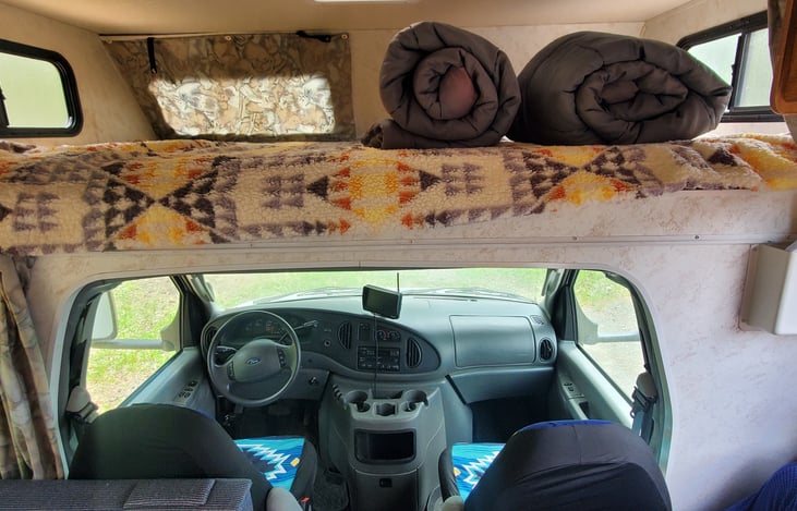 Drivers area with back up camera and over head sleeping area