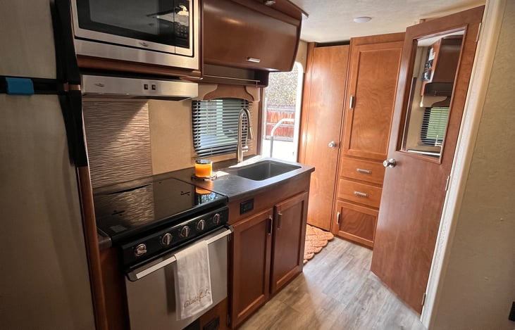 Kitchen w stove, oven, large fridge, microwave and storage.
Coat closet and storage drawers stocked w kitchen essentials