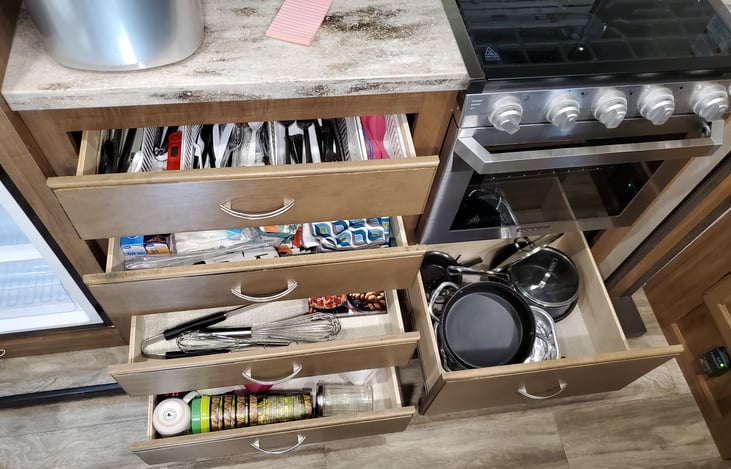 Full kitchen equipped with spoons, forks, knives, cups, pots, pan, etc...