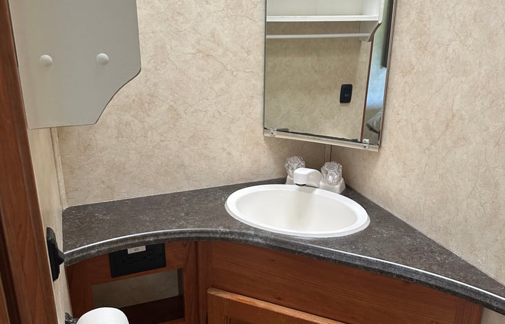 bathroom includes; sink, toilet, shelves x3, two cabinets