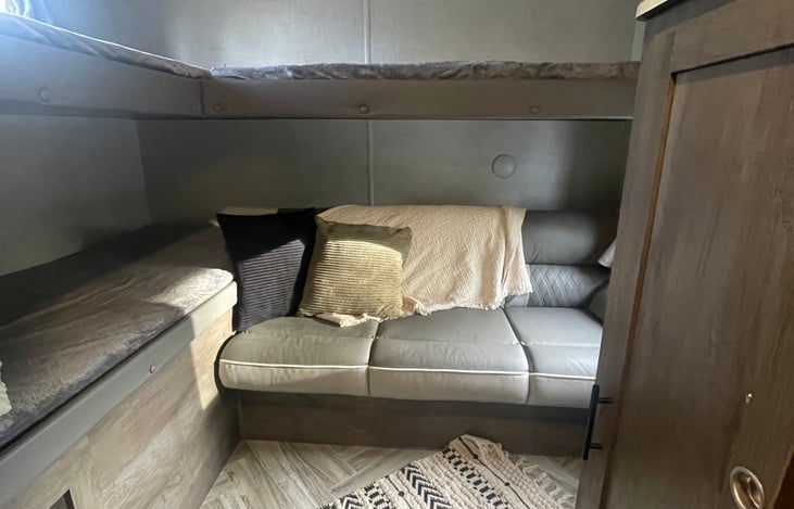 Bunkhouse with 3 single bunks and a pull out couch. Storage under couch and mini closet