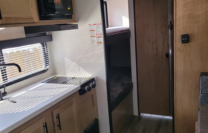 Kitchen ,bunk beds, door to bathroom and the refrigerator.