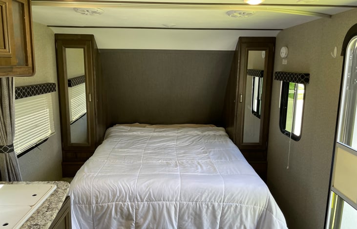 Front murphy queen bed setup at the front of the camper. Rental comes with fitted sheet, top sheet, and comforter for this main bed.