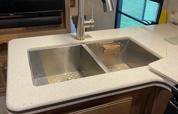 Double kitchen sink with stainless steel faucet.