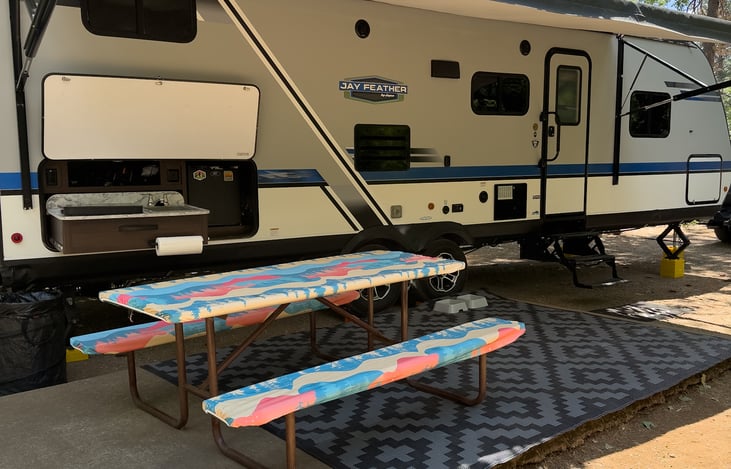 We also supply picnic table covers and outdoor rugs! Not pictured are camping chairs and a camping loveseat!