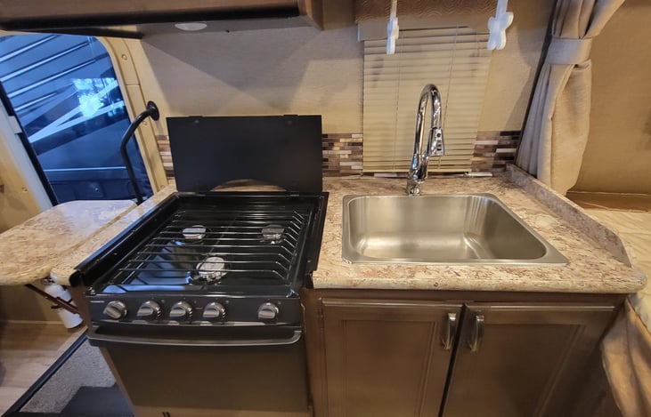 Camp cooking is usually done outside but on the occasion where the elements aren't cooperating, Thor has outfitted this motorhome with just what you need. Range, oven or microwave.