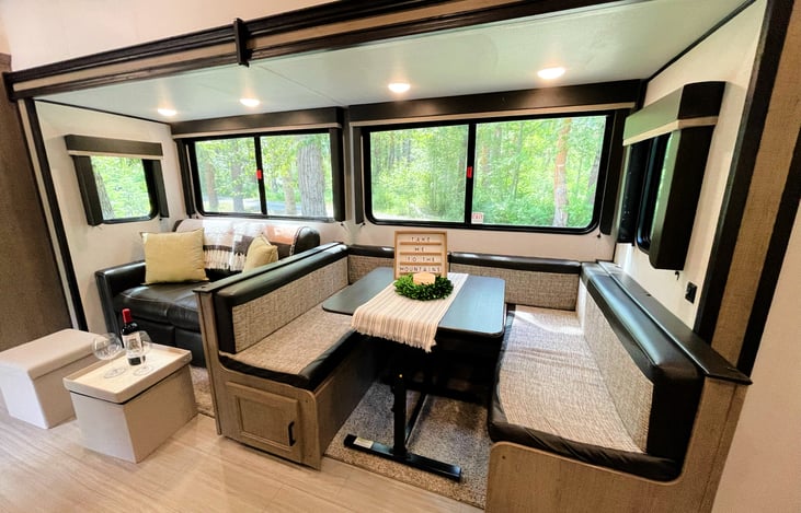 Panoramic windows surround the living and dining area for natural light and scenic views. Booth dining area converts to a full size bed. Add a customizable welcome message for family and friends!