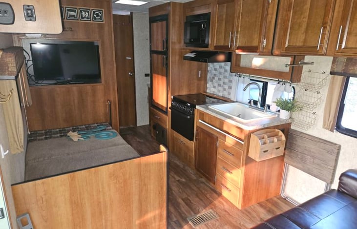 Kitchen galley table down, refrigerator and freezer closed.
