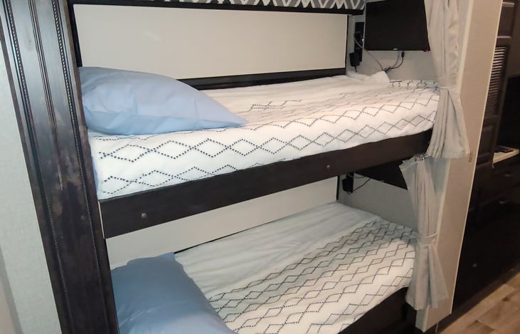 Bunk beds with foam padded mattress, TVs/DVD players.  Curtains provide privacy for sleep-time.