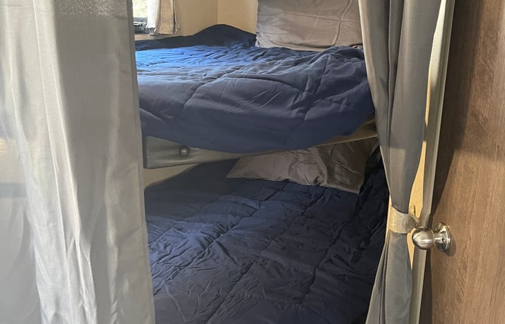 Duel bunks with privacy curtain and individual privacy lights.