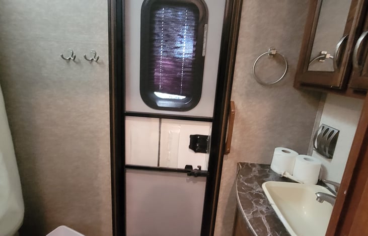 Bathroom off bunk house with exterior door.