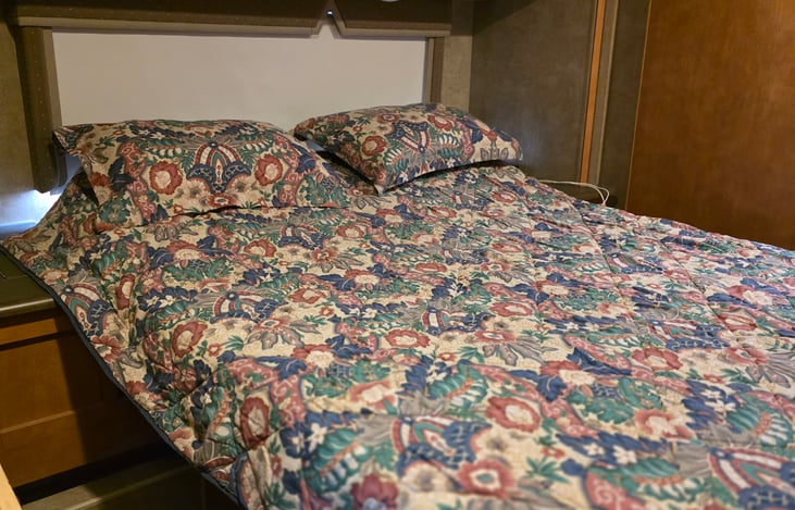 Queen bed with 3" memory foam topper. Also wedge head risers.