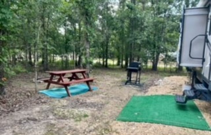 Your outside space include a picnic table, grill, firepit with grilling option and surrounding trees.
