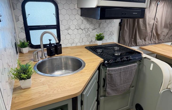 Functional RV kitchen with sink, stove & counter space – convenient cooking while traveling