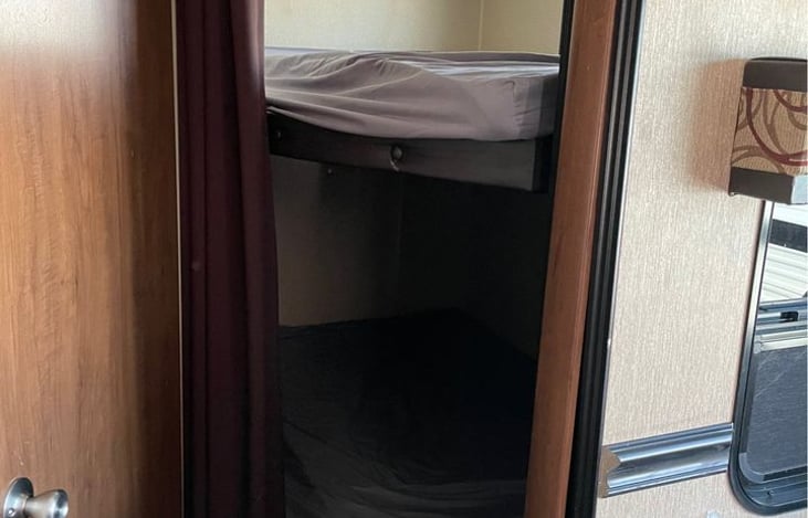 Full sized beds on bunk bed and storage underneath