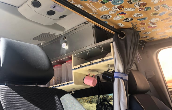 Tent, sleeping bag, inflatable mattress storage above crew area.  New stickers are always welcome:)