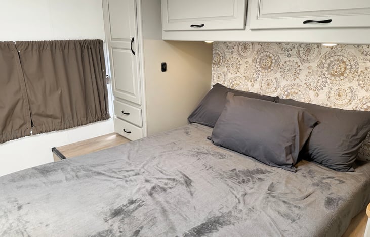 Comfortable private RV bedroom with generous sleeping space & storage for extended adventures