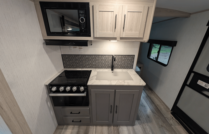 Spacious and accommodating interior with smart TV, fireplace, music system, comfy couch, large dinette, full bathroom, large refrigerator, kids bunkhouse and more.