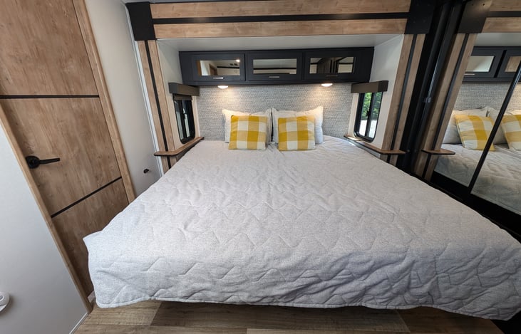 Comfy King bed with ample storage in the bedroom.