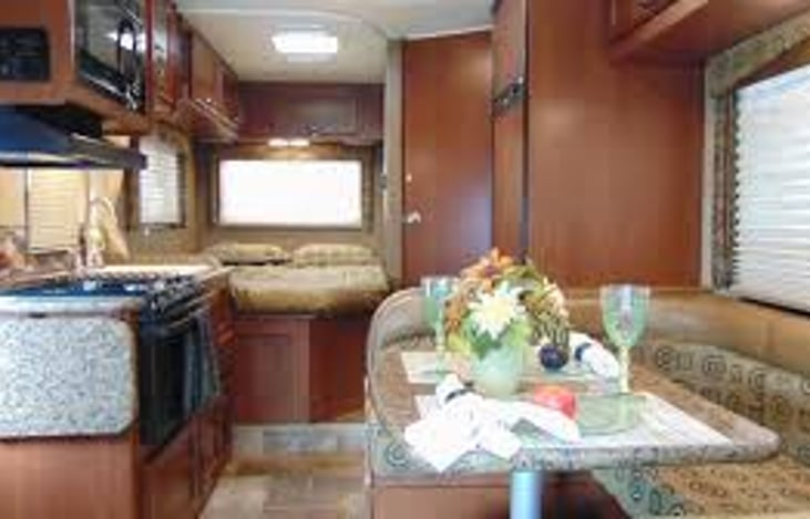 Dinette to the right, kitchen left, master bed & bathroom door and refrigerator to the right.