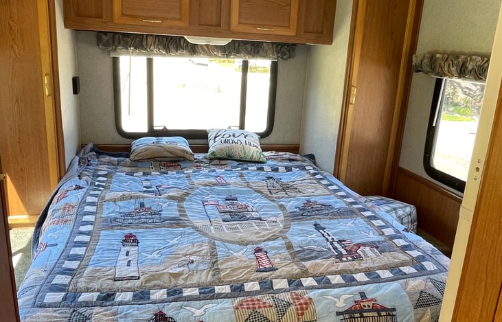 Queen bed with space on each side for comfortable living.