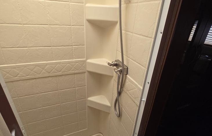 New shower head with wand and new shower curtain 6 gallon hot water ********* girls were able to wash all of their long hair and still have hot water left.