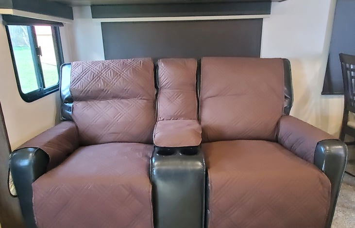 Recliners with a console and cup holders.