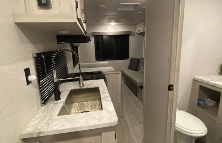 Large basin sink with sprayer faucet.