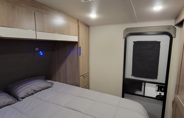 Private entrance to master bedroom with plenty of storage and nice reading lights above the bed.