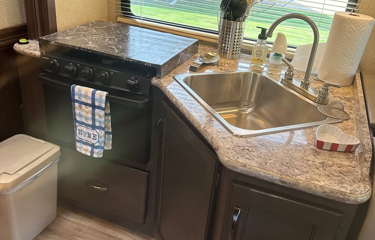 Kitchen sink and stove with oven.