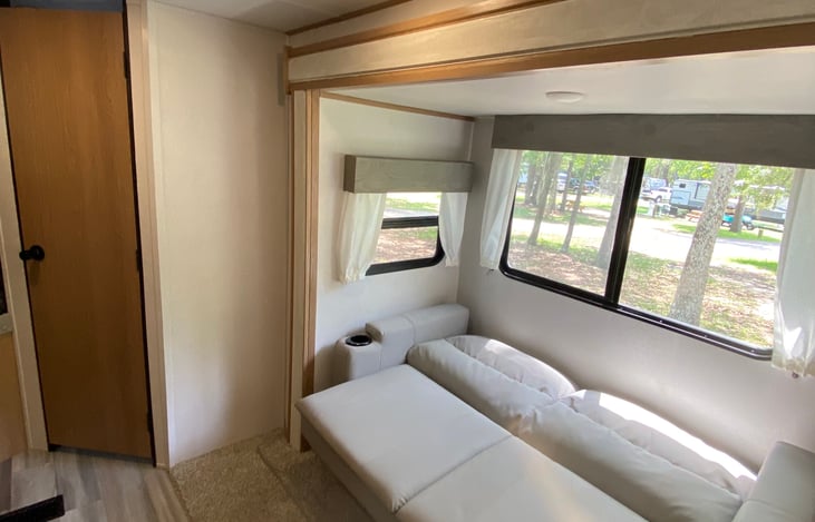 COUCH FOLDED OUT INTO ADDITIONAL BED AREA