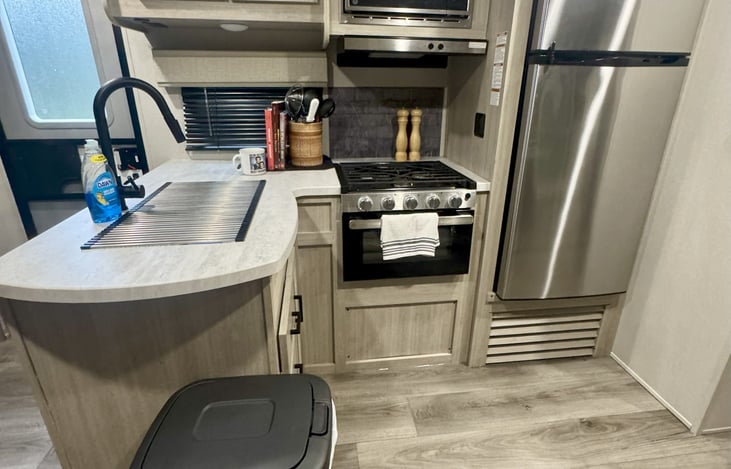 Full kitchen stocked with basic kitchen essentials and plenty of fridge and freezer space.