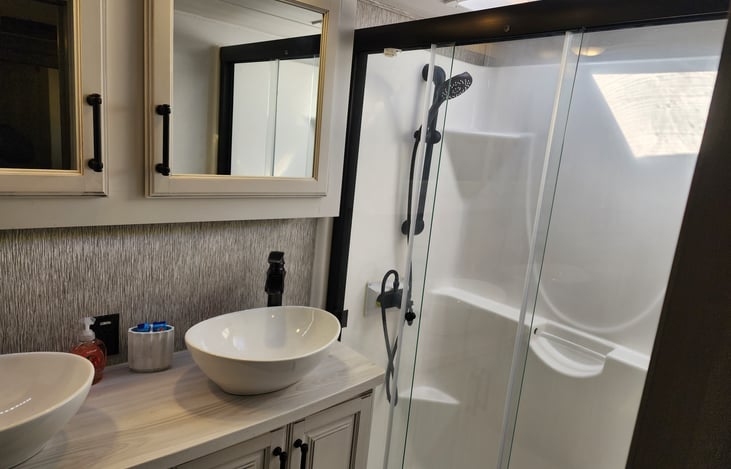 Good size walk in shower with skylight. Double sink and very spacious.