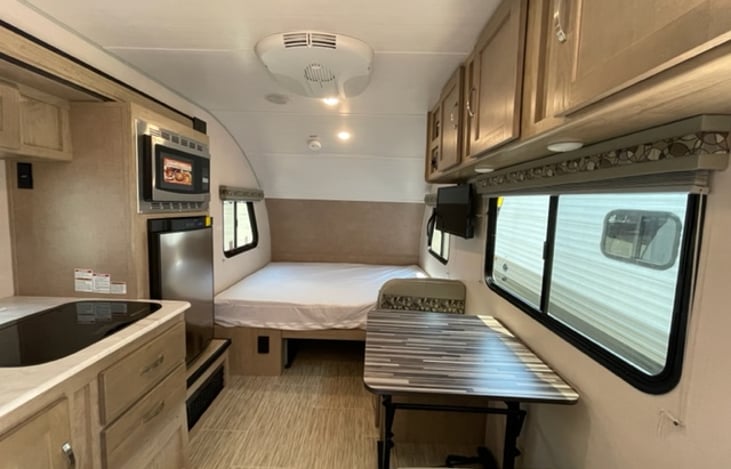 Retreat to the comfort of the travel trailer's queen-size bed and experience a restful night's sleep.