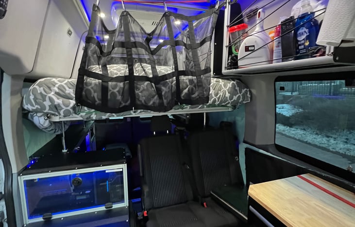 The bed is shown in the upper position. The height of the bed is adjustable but should be raised, and mesh netting attached, before driving