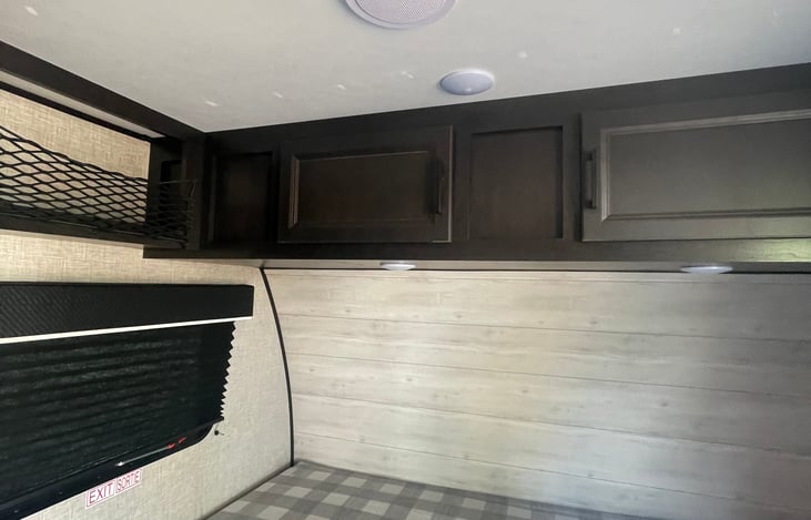 Corner vinyl walls next to queen bed. New