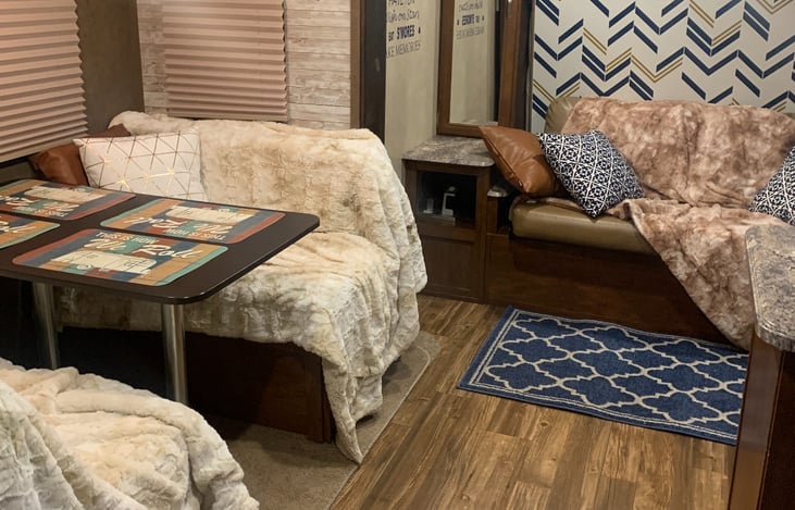 Murphy bed with upgraded mattress drops down behind the couch