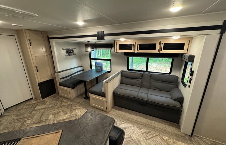 Dinette table and sleeper sofa. Small double. Bedding under sofa.