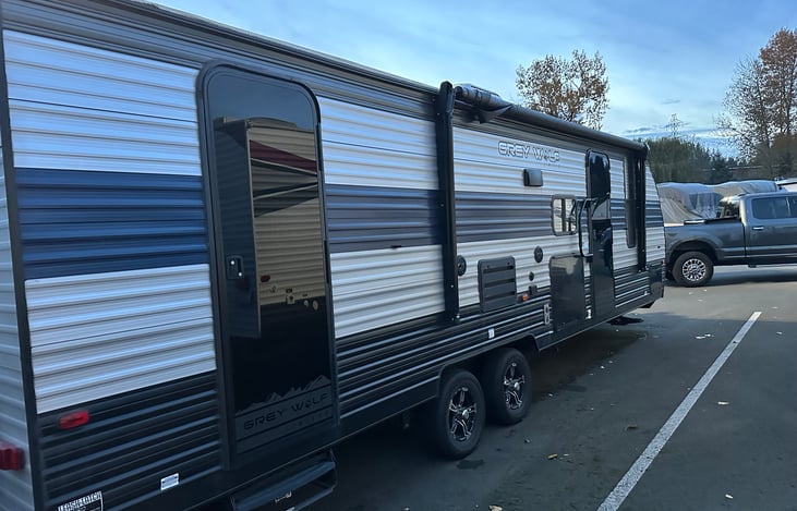 Side Profile Awning side. Two entrances, one to the main area and the rear door accesses the Restroom