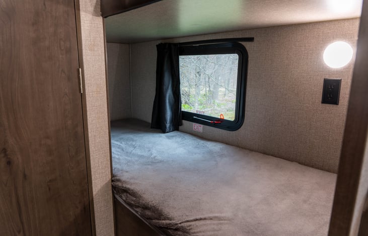 Lower Bunk: Opening Window (With Blackout Curtain), Wall Outlet and Light