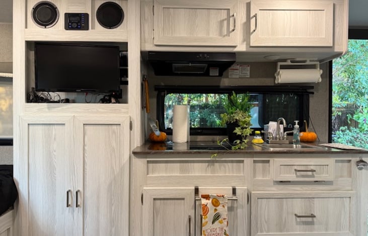 Everything you need in the kitchen to include stove, microwave, refrigerator, utensils, dinnerware, cookware, and a French press!