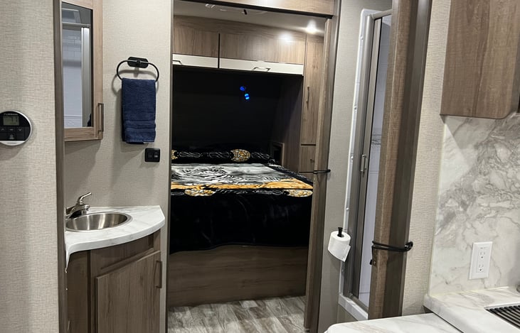 privacy restroom is between the kitchen and the master bedroom. Bed has a queen size house-hold mattress.