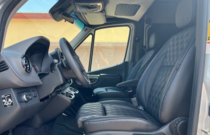 Leather heated massaging chairs in front and 2 in back